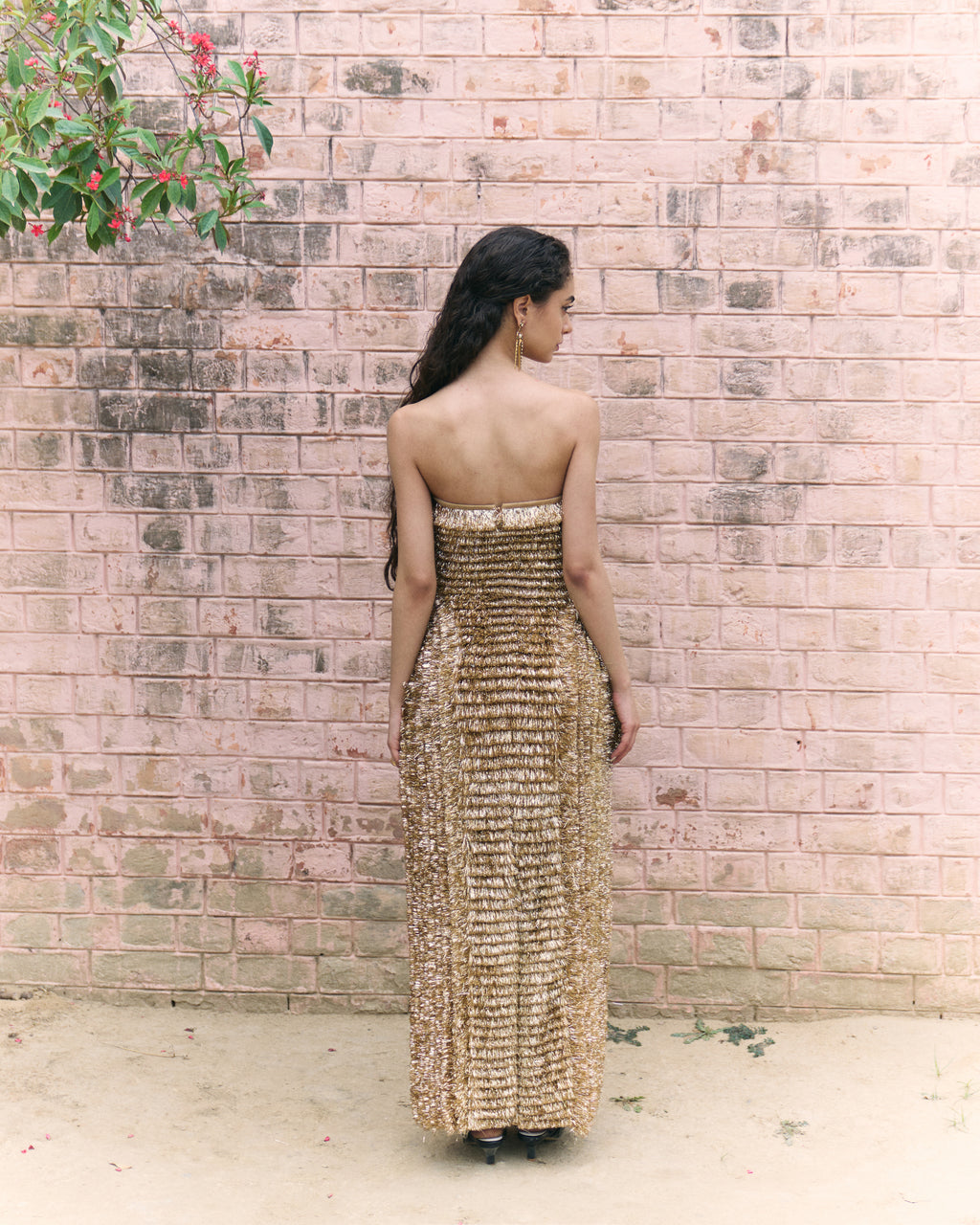 Golden strapless gown made of traditional indian kiran.