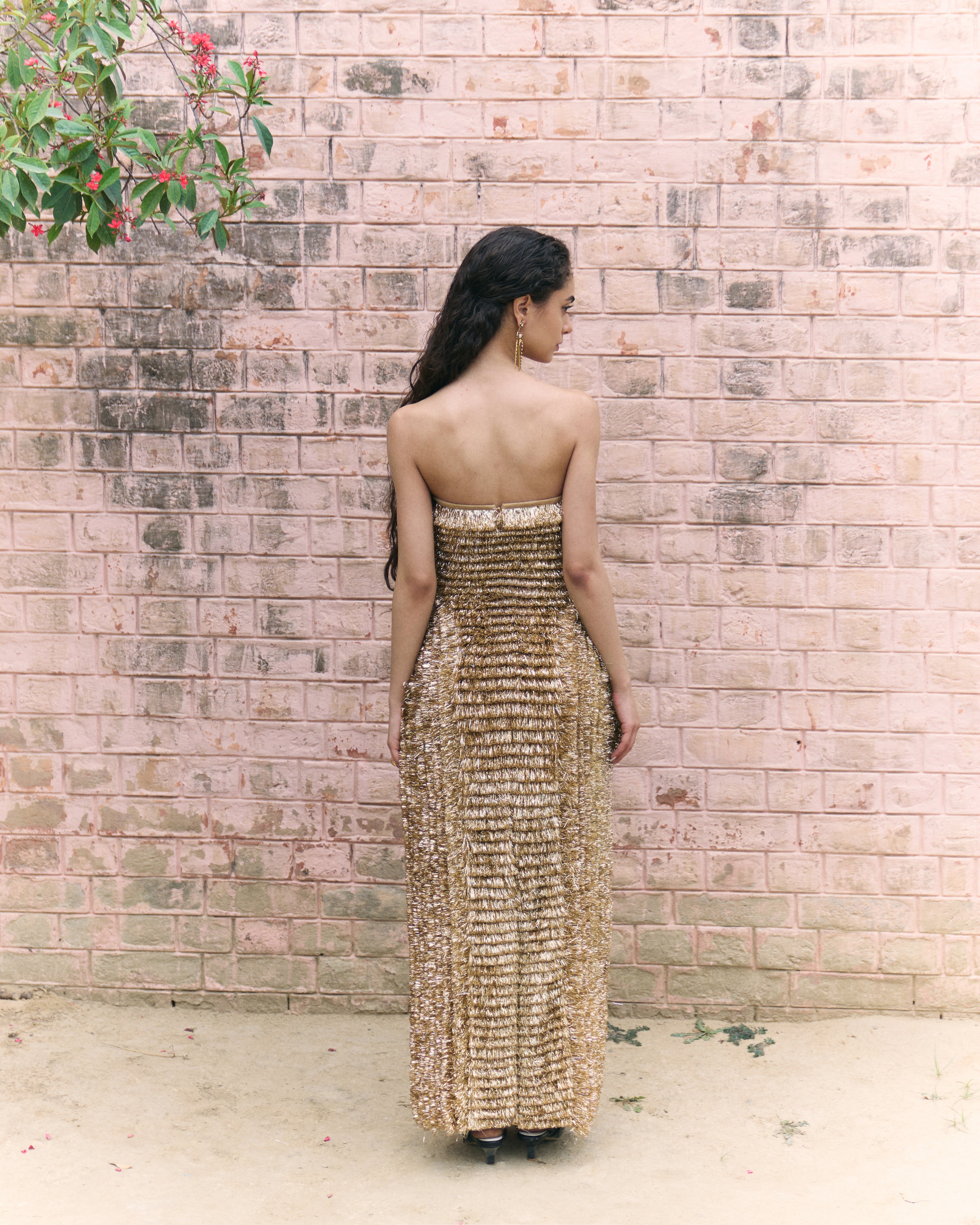 Golden strapless gown made of traditional indian kiran.
