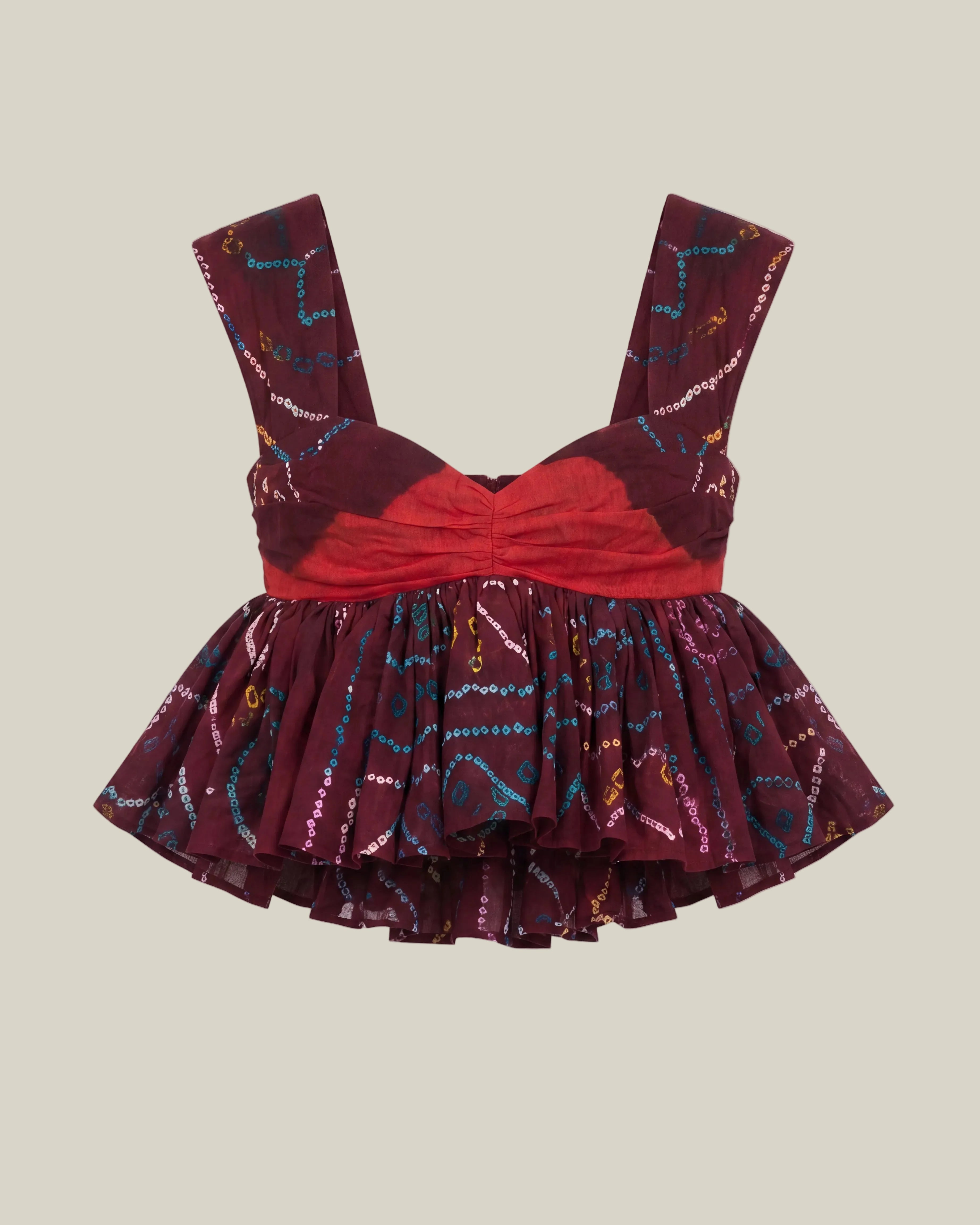 A sleeveless ruffled top with a sweetheart neckline, featuring a bright red gathered bodice and a tiered skirt in deep burgundy with colorful abstract line patterns, shown against a plain white background.