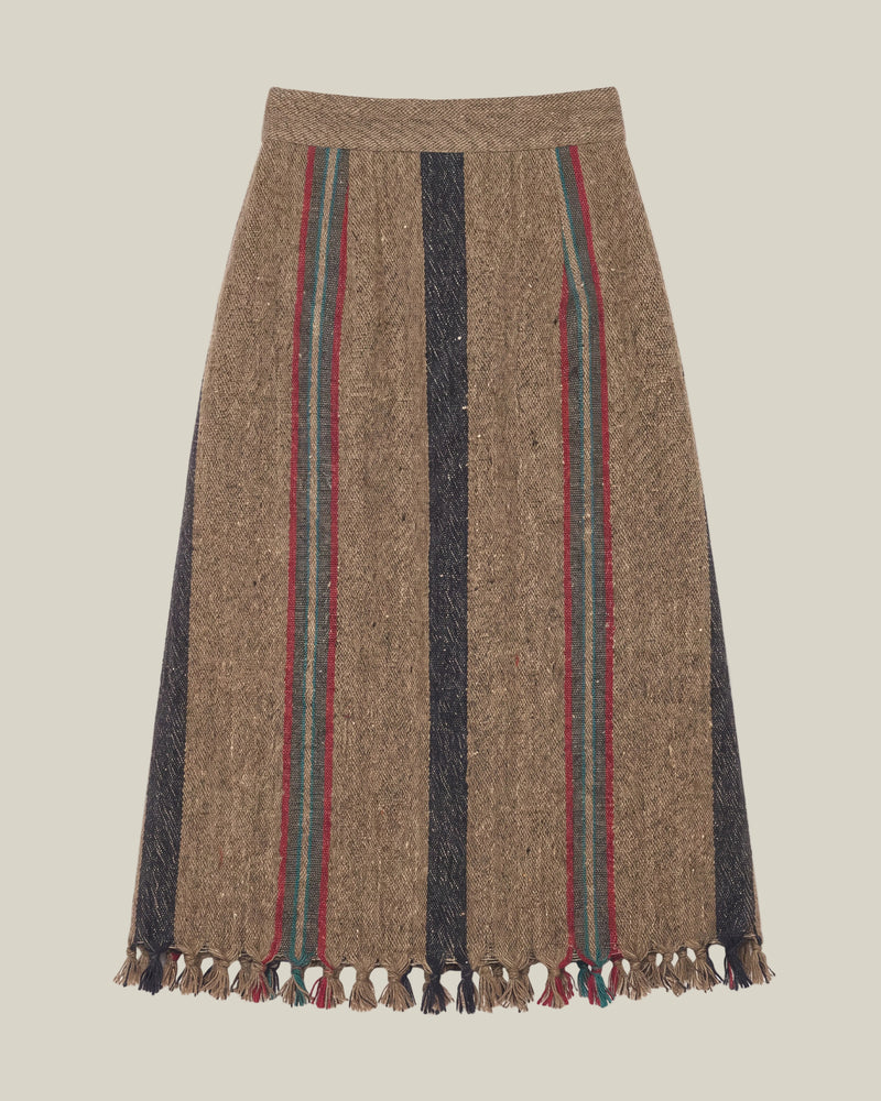 A brown wool skirt with vertical stripes in black, red, and green, finished with a fringed hem.