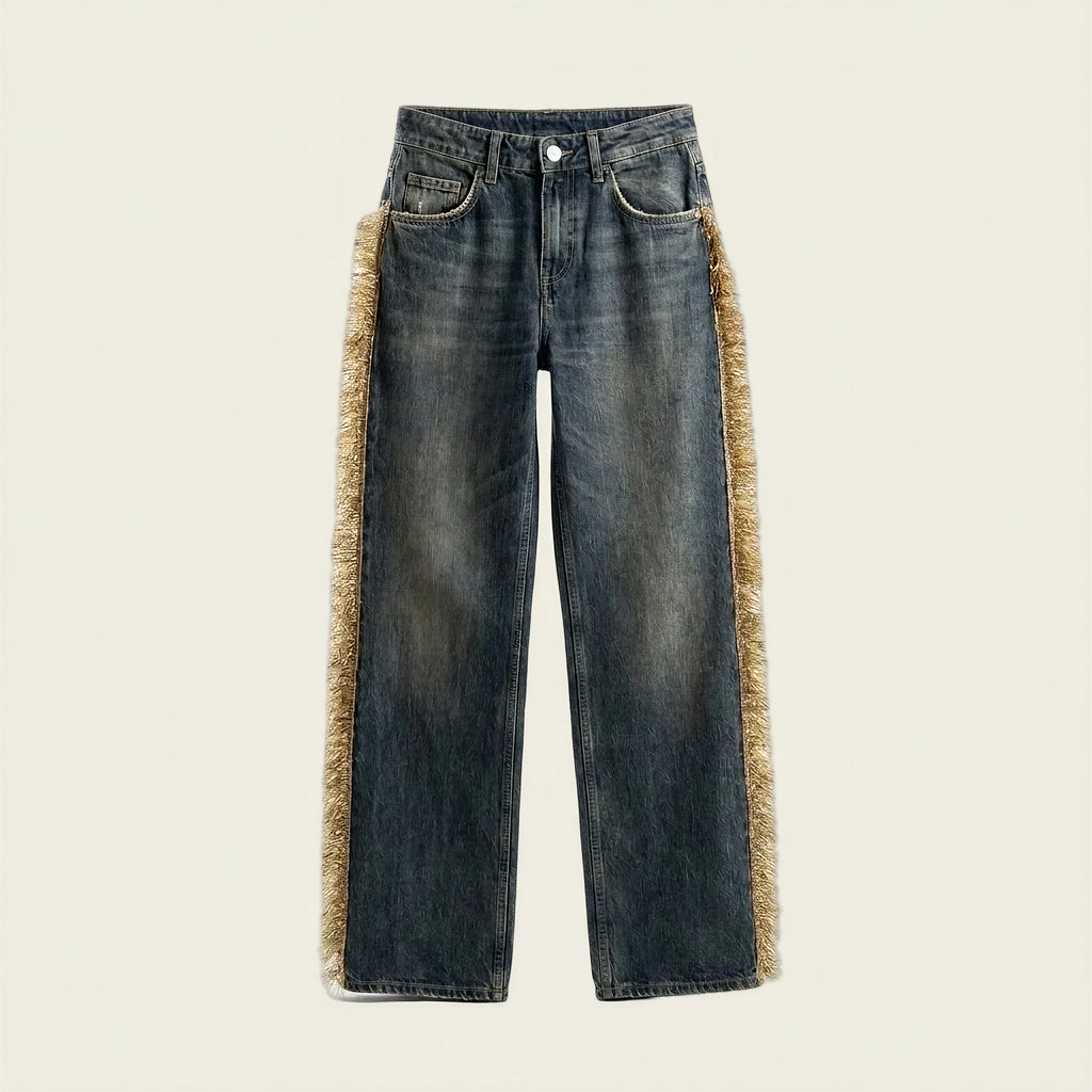 Dark blue denim jeans with a beige faux-fur trim running down the outer sides of the legs, shown flat against a light cream background.
