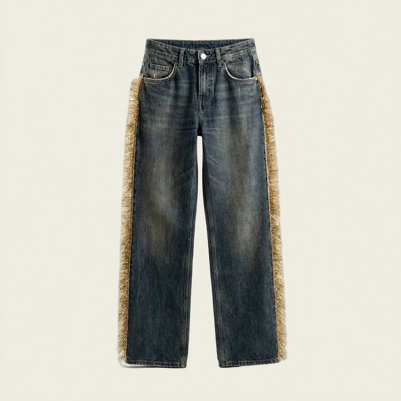 Dark blue denim jeans with a beige faux-fur trim running down the outer sides of the legs, shown flat against a light cream background.