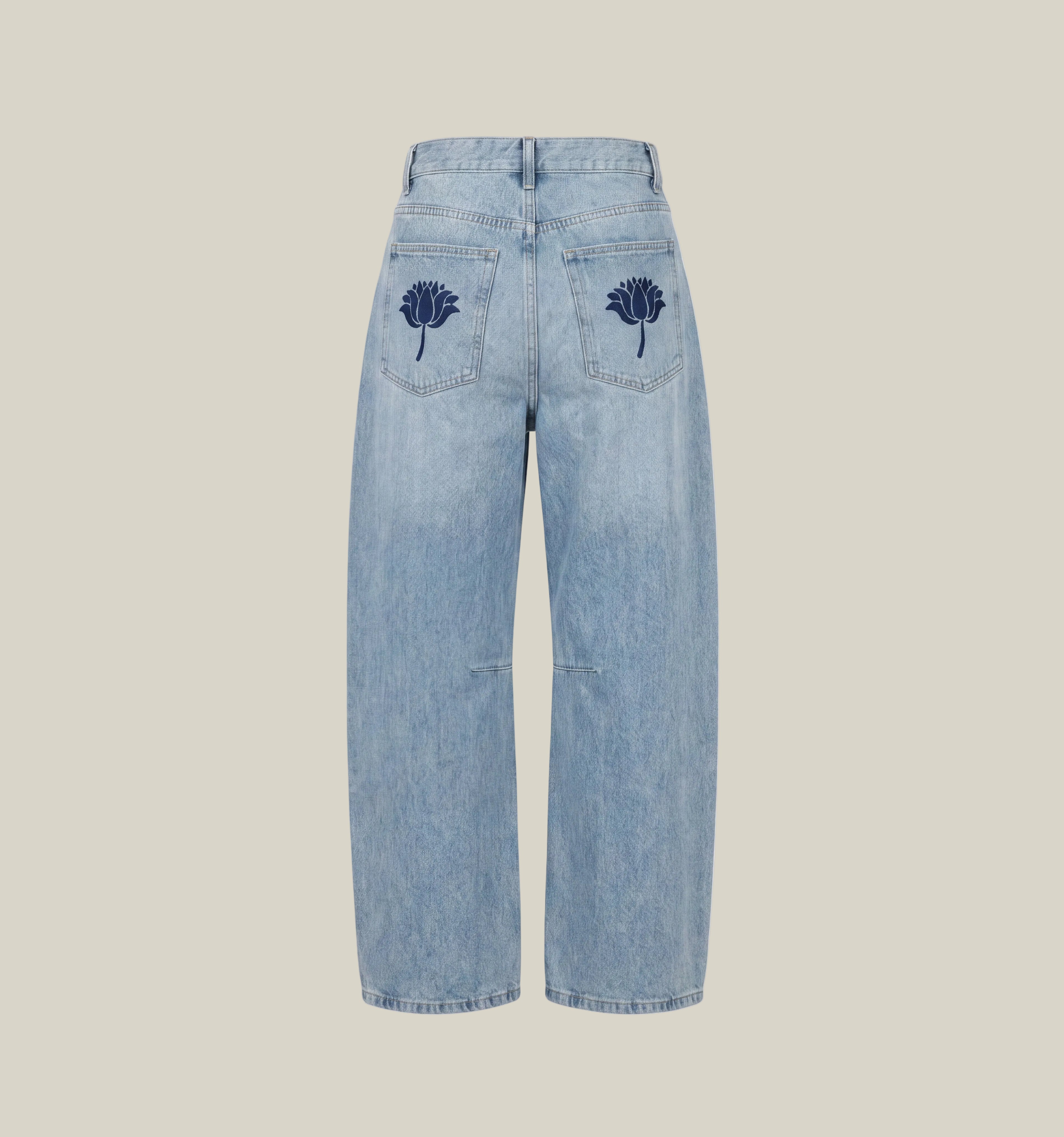 Light blue denim cropped jeans shown from the back, featuring dark navy embroidered lotus flowers on both rear pockets, set against a plain white background.