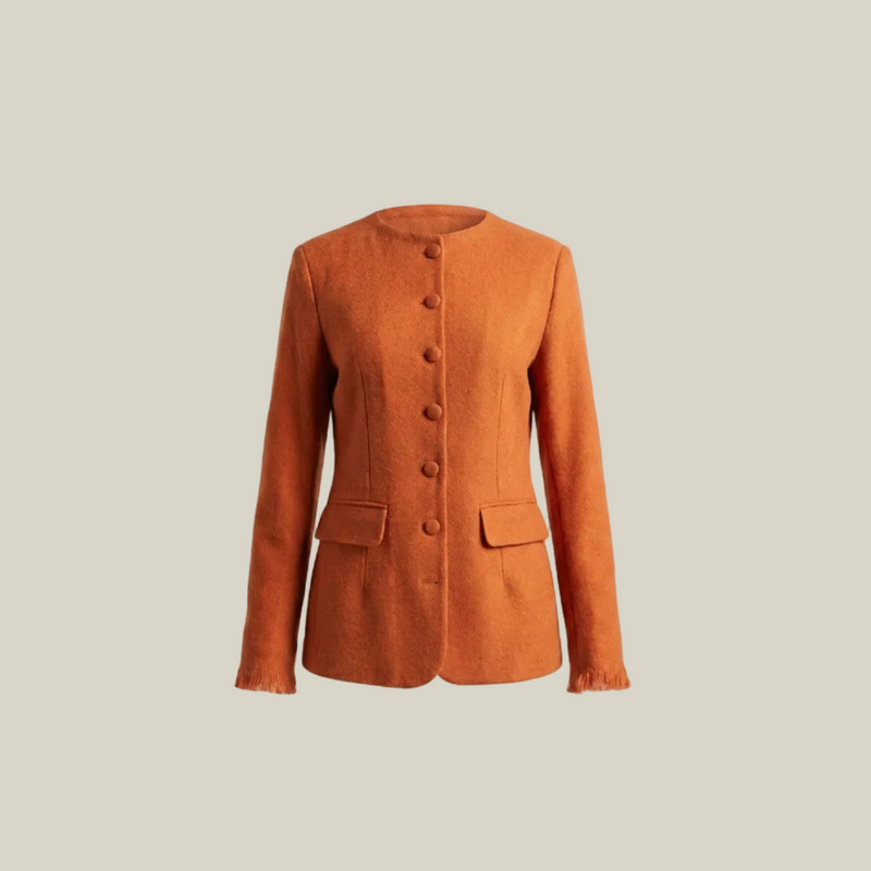 An orange textured wool-blend jacket with a round neckline, button-front closure, and flap pockets, shown against a solid off-white background.