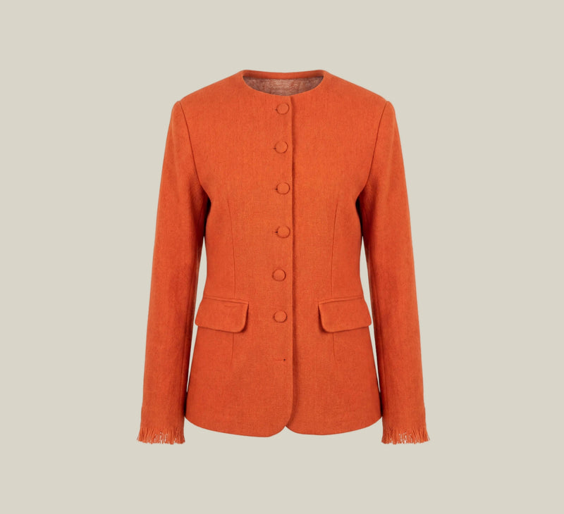 An orange textured jacket with a round neckline, button-front closure, and flap pockets, presented on a white card against a light beige background.