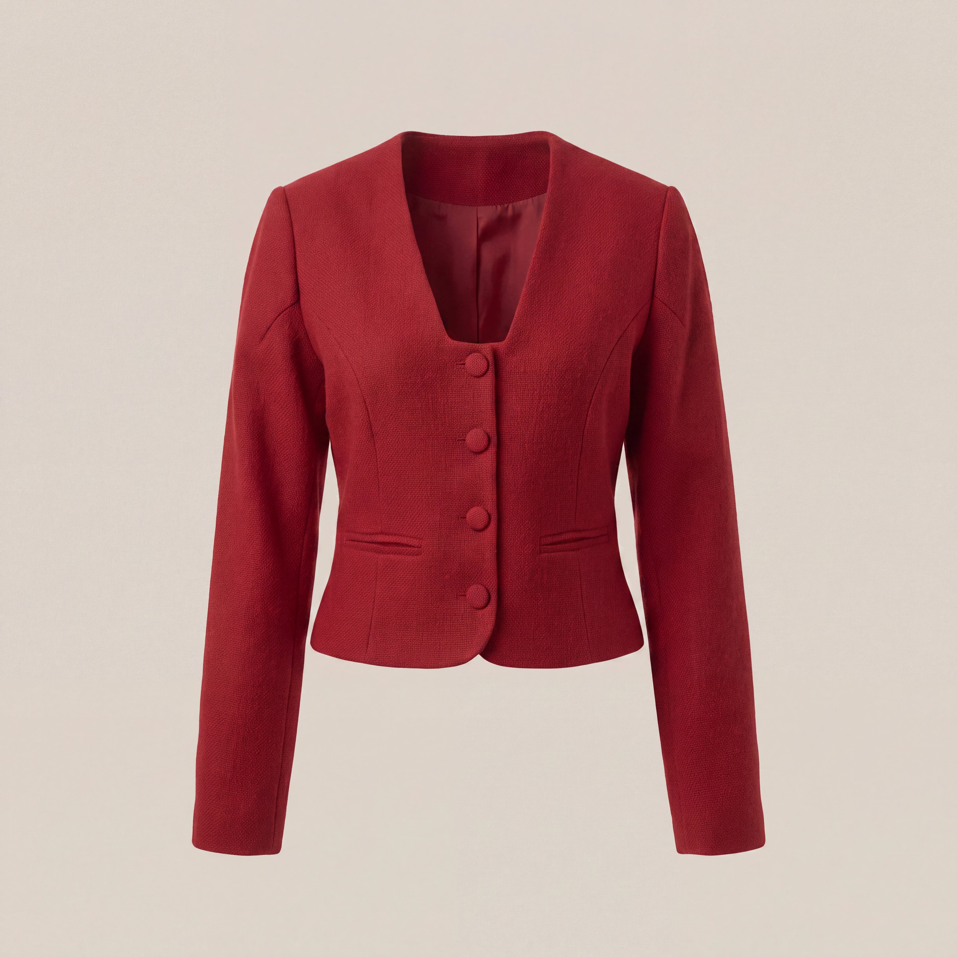 A red cropped long-sleeve blazer with a V-neck, three front buttons, and welt pockets, shown on a plain beige background.