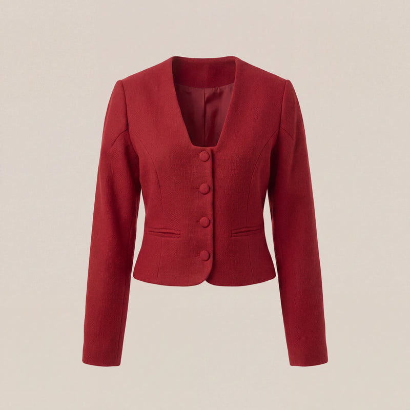 A red cropped long-sleeve blazer with a V-neck, three front buttons, and welt pockets, shown on a plain beige background.