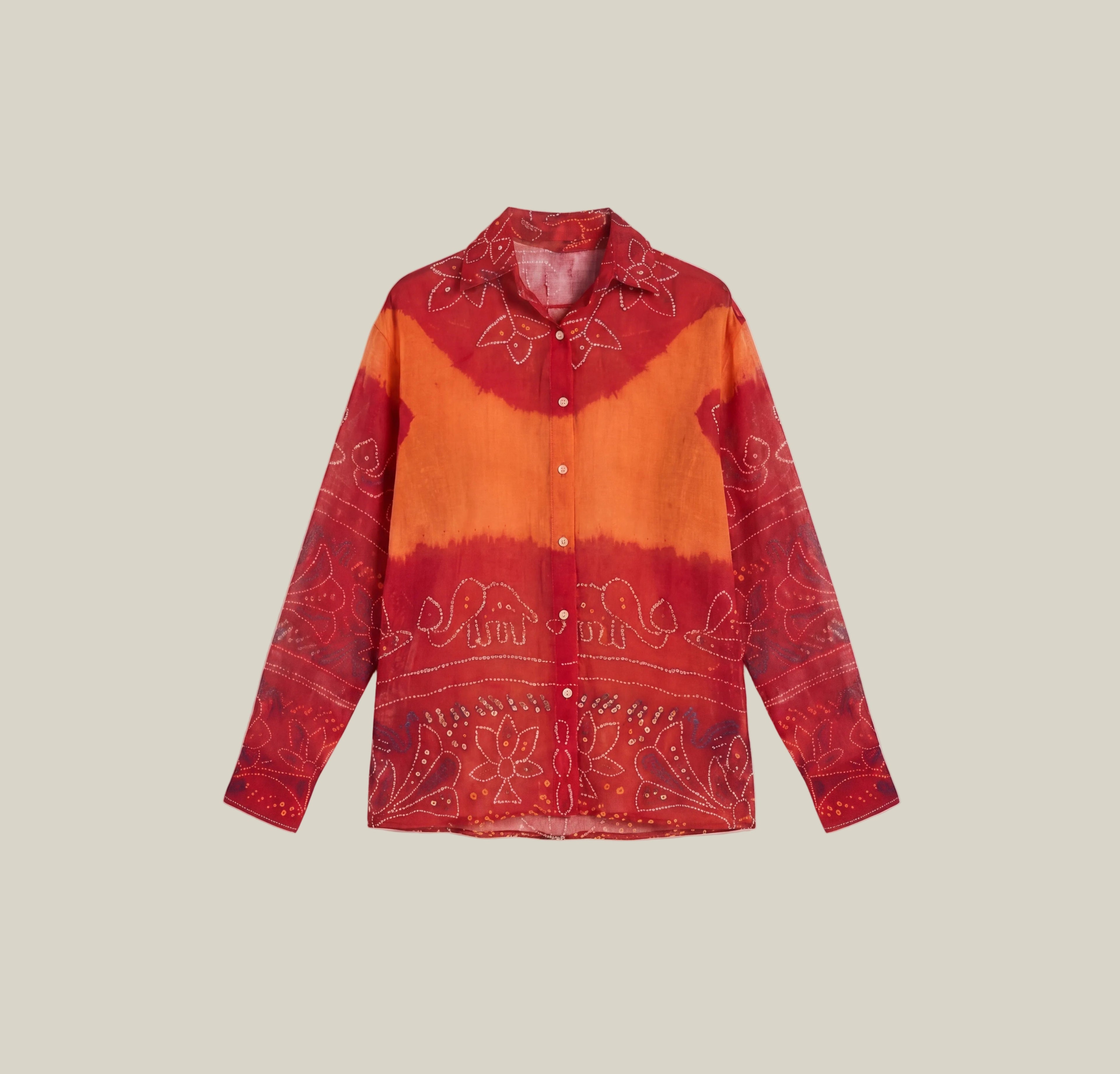 A long-sleeve button-up shirt with a red and orange tie-dye pattern and white paisley embroidery, displayed flat against a light beige background.