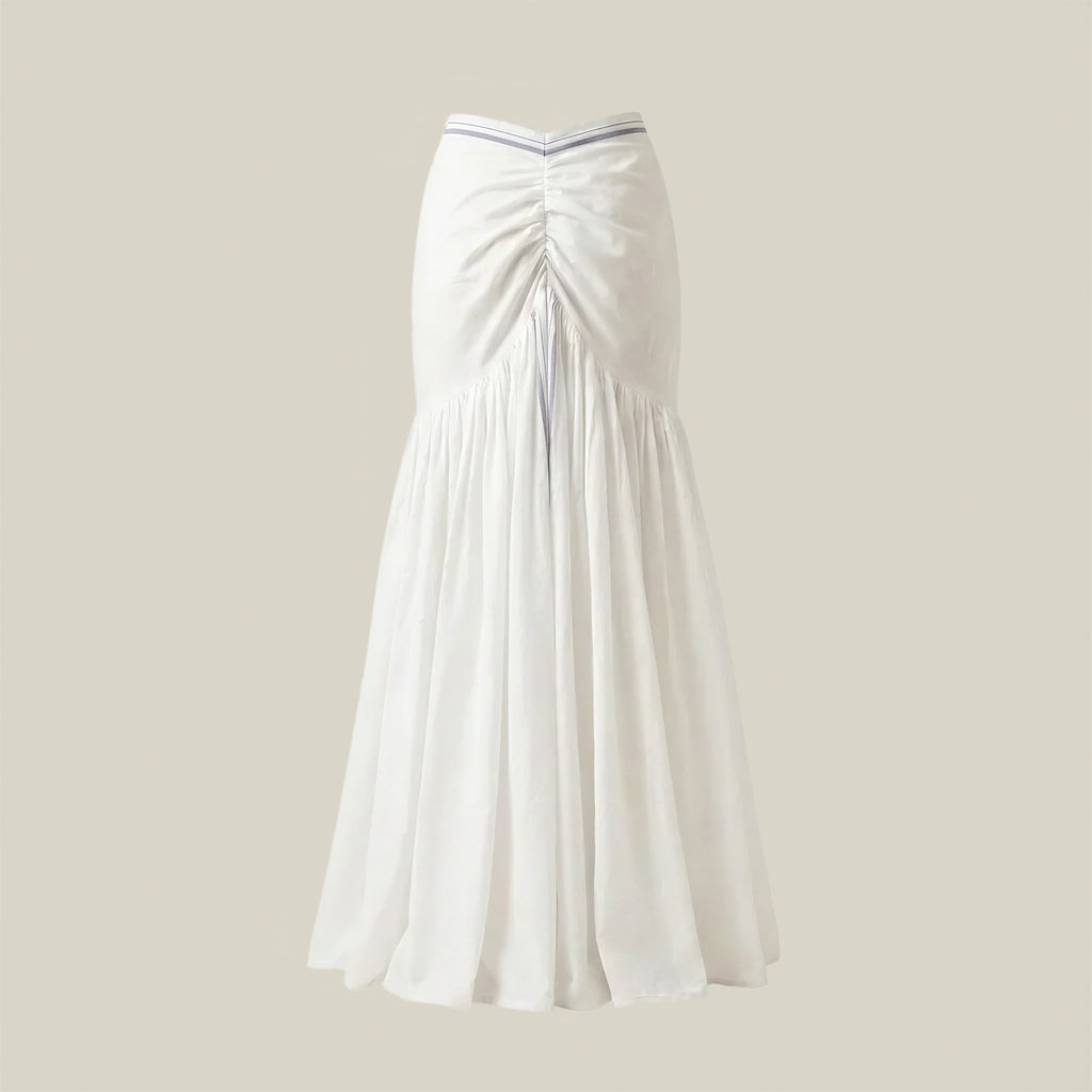 White pleated skirt on a beige background