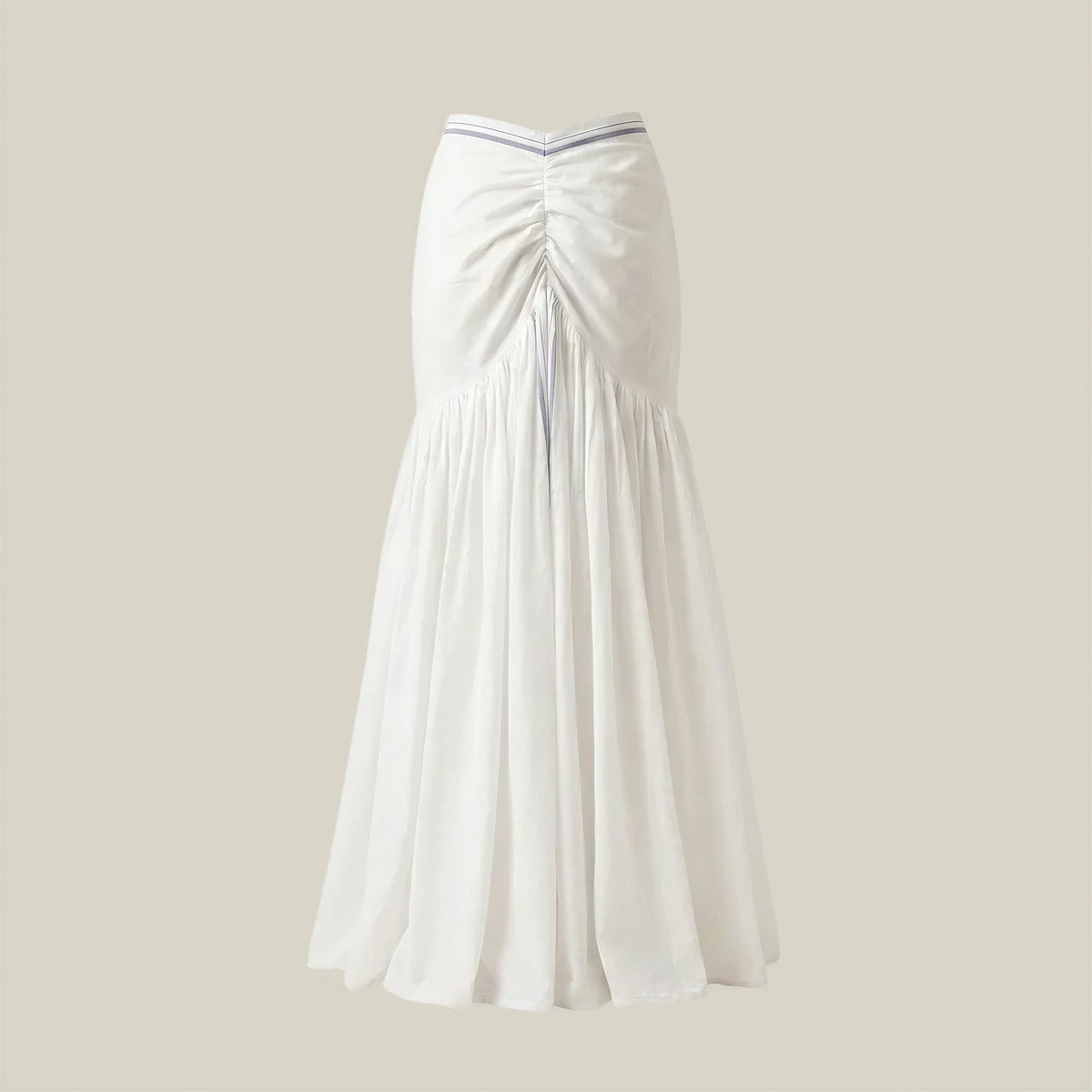 White pleated skirt on a beige background